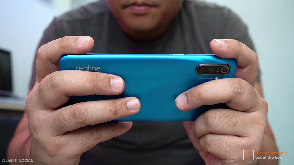 man playing a game on the Realme C3