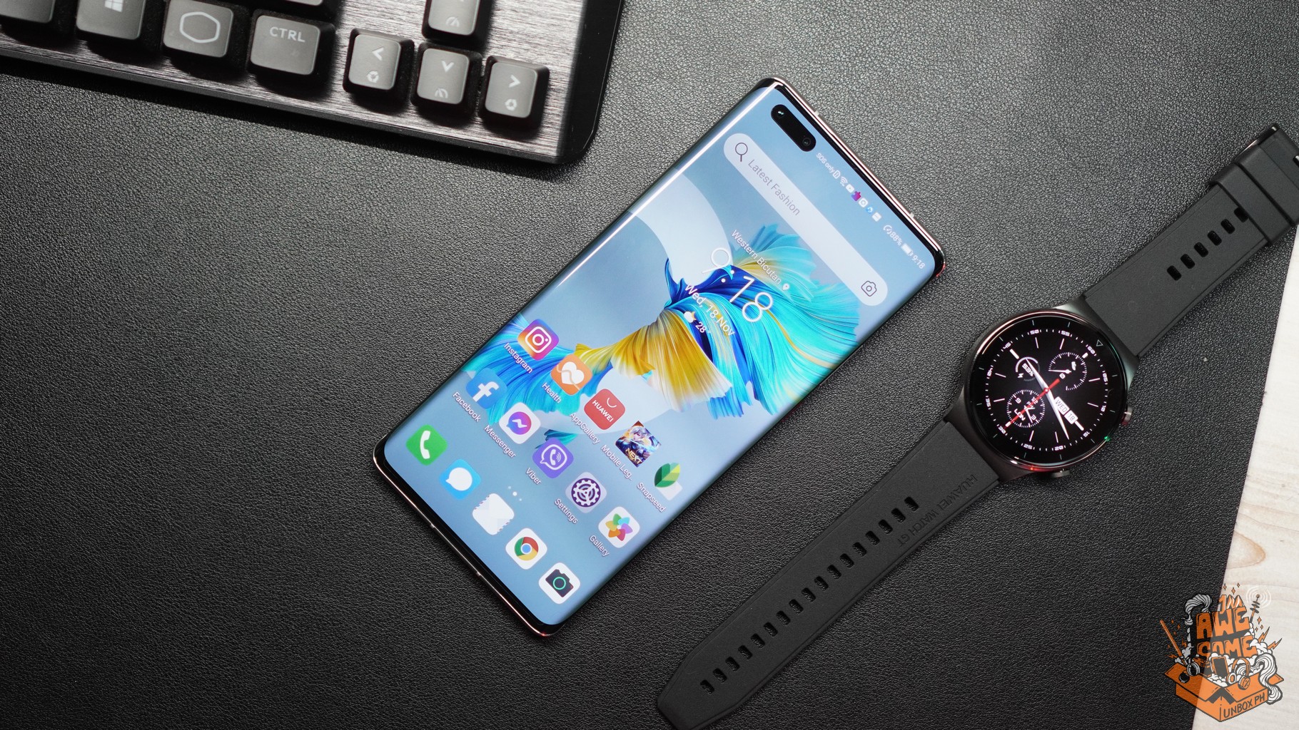 Photo of Huawei Mate 40 Pro on a table with a watch