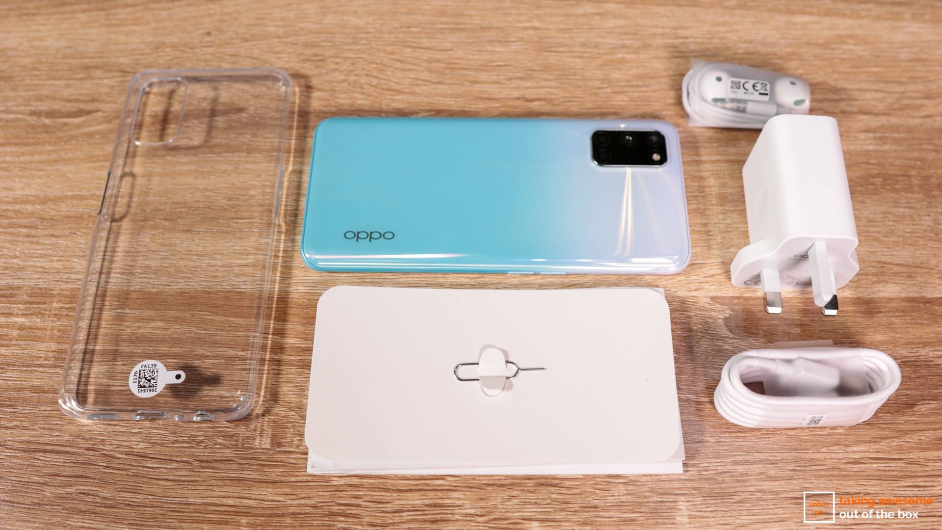 Oppo A92 unboxing with the phone, charger, earphones, silicon cover, and user manual