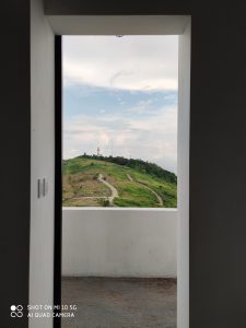 Photo of a hill from inside a house using the Xiaomi Mi 10